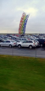 KEF Airport has a rainbow that leads to a pot of cars.